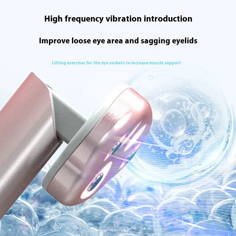 Gradient pink Cat's Paw micro-current eye massager with charging cable.