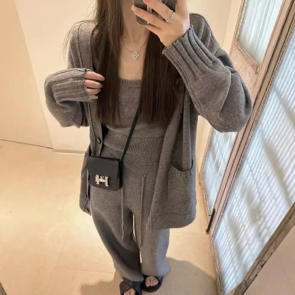 Women's loose-fit wool-blend cardigan three-piece set with vest and suspender trousers in beige.