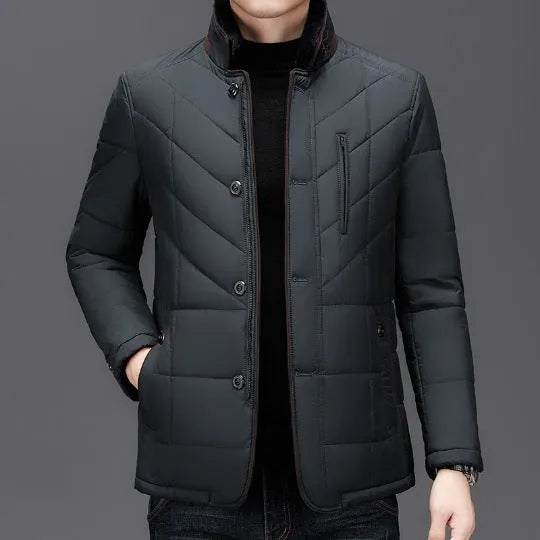 Men's dark blue short winter coat with side pockets and a full zip, showing cotton-padded construction.