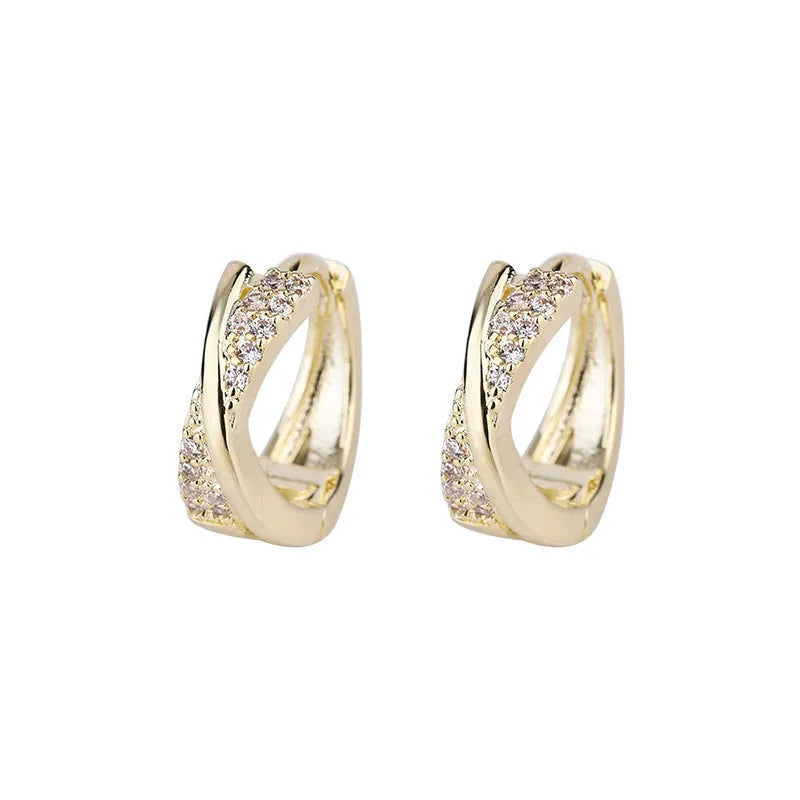Pair of geometric drop earrings in 14K yellow with zircon treatment on a copper base.