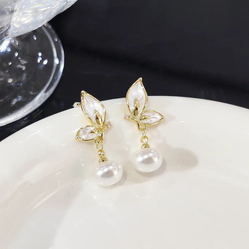 A pair of simple zircon butterfly stud earrings for women with copper electroplated finish.