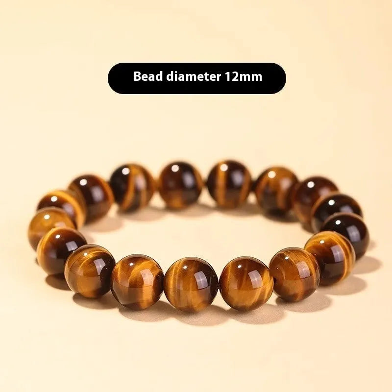 Single circle tigereye Dzi bead Buddhist mala bracelet shown on a wrist.