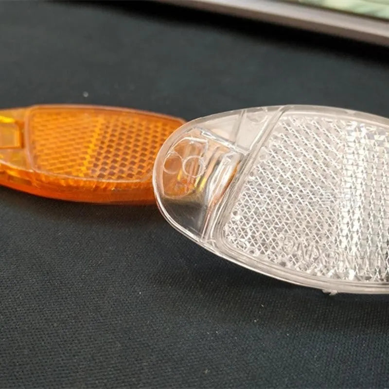Yellow and white bicycle spoke reflector measuring 7.2cm by 3.5cm for front and rear wheel safety