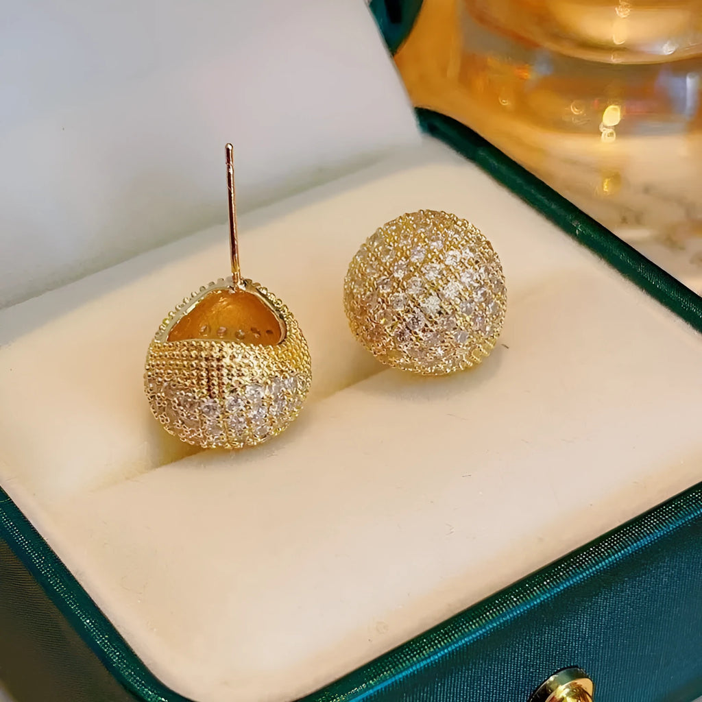 Geometric drop earrings with diamond accents and golden beans in gold and white colours