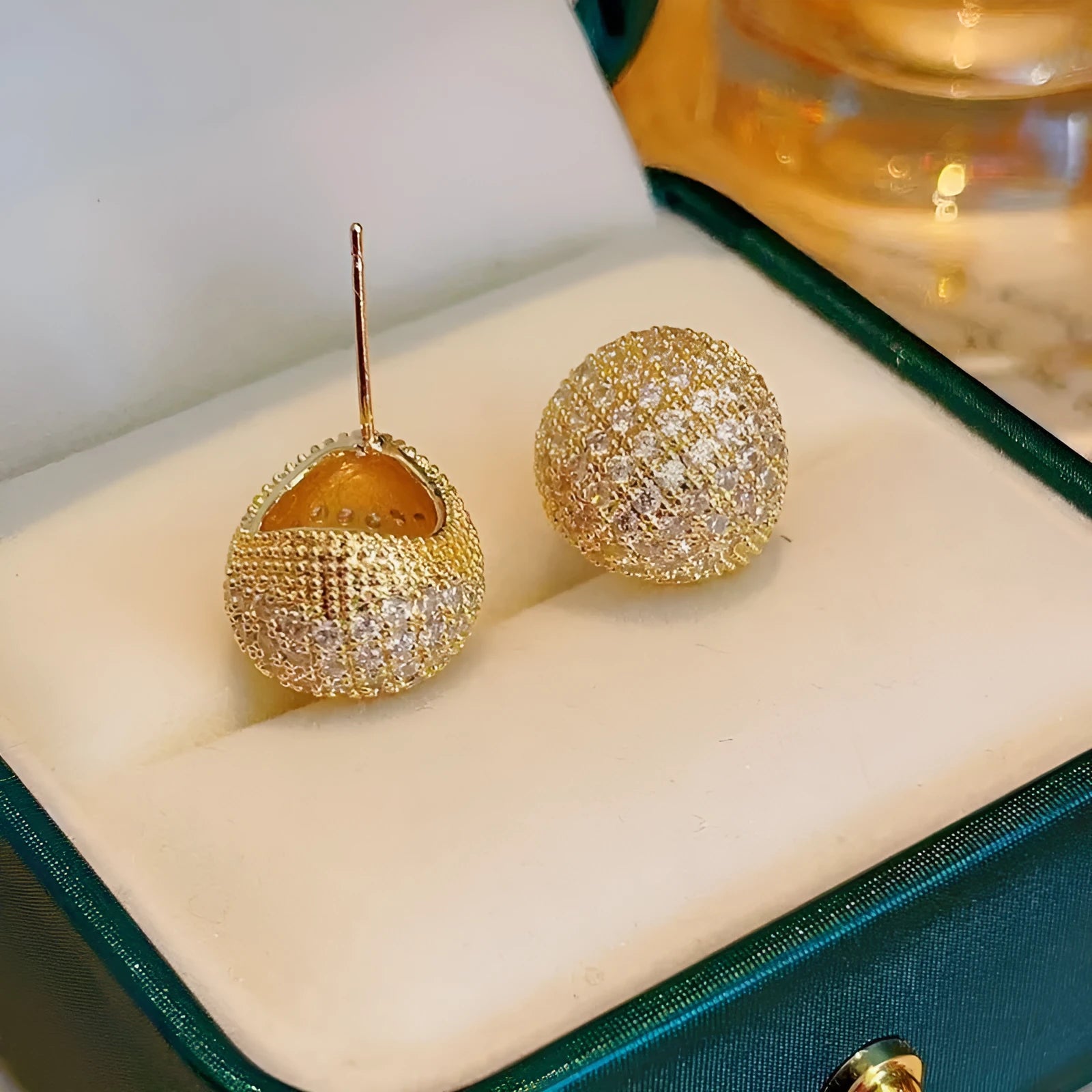 Geometric drop earrings with diamond accents and golden beans in gold and white colours