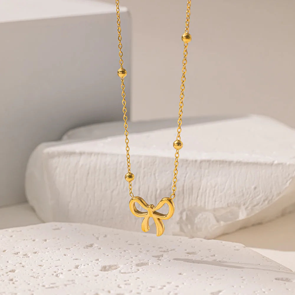 Gold bow necklace on titanium steel cross chain with adjustable 41-50cm length