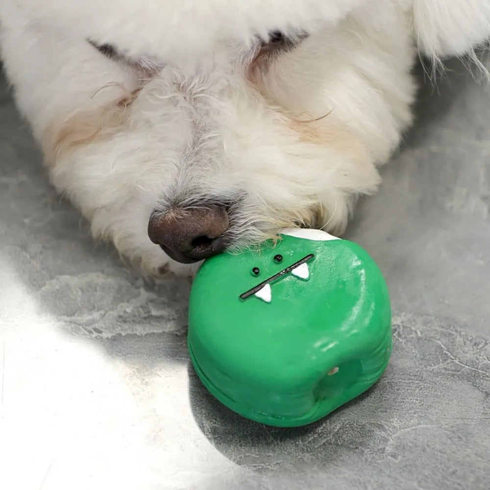 Yellow and green bread-shaped latex dog squeaky toy with cartoon pattern on a white background.