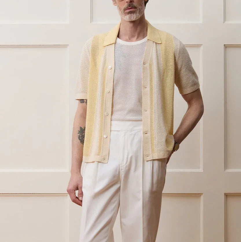 Yellow asymmetric hollow-out short sleeve polo shirt made from Tencel fabric on a model.