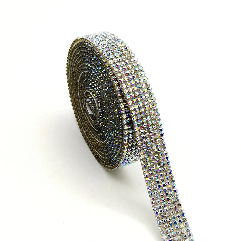 A 1 yard long strip of self-adhesive glass water drills in white and AB colour for clothing decoration