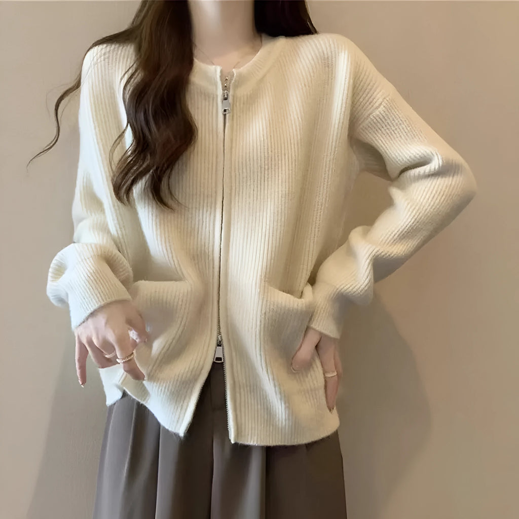 Beige viscose fibre long sleeve cardigan sweater coat laid flat, showing button front and soft texture.