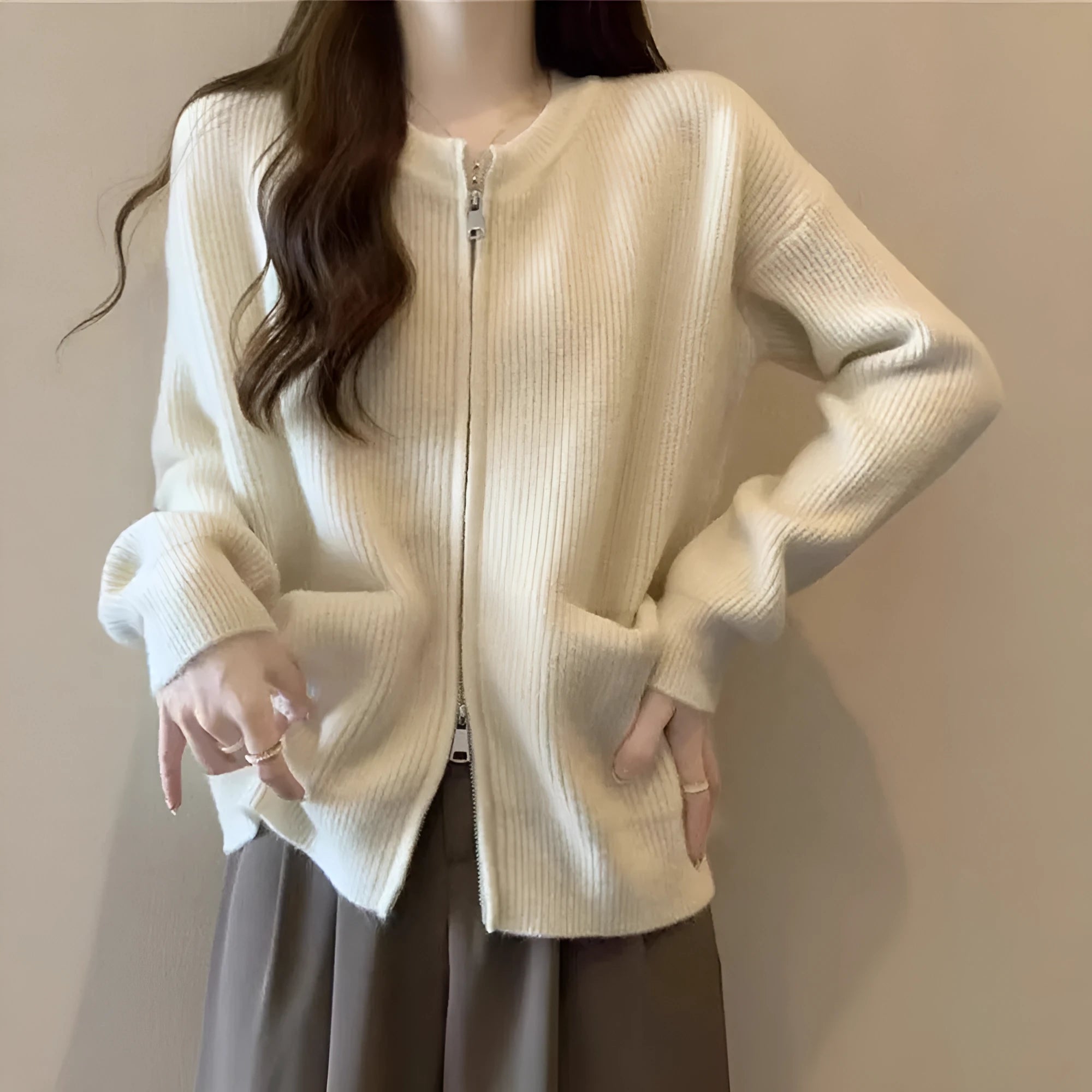Beige viscose fibre long sleeve cardigan sweater coat laid flat, showing button front and soft texture.