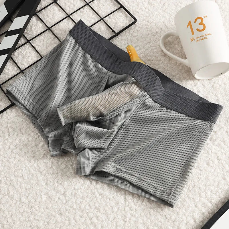 Men's solid colour ice silk boxer shorts showing low waist and breathable mesh fabric.