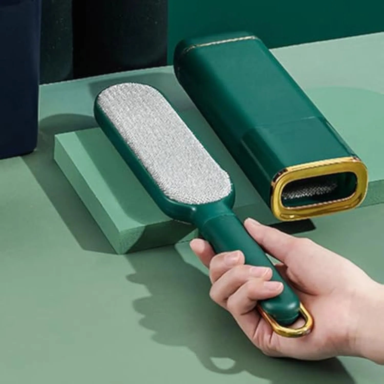 Blue, green, and white double-sided pet hair remover brush with storage base.