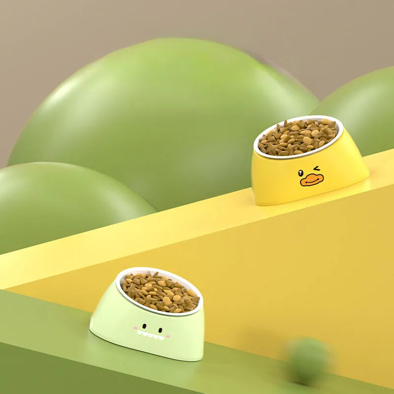 Green tilted pet feeding bowl with stainless steel insert and plastic base for cats and dogs.