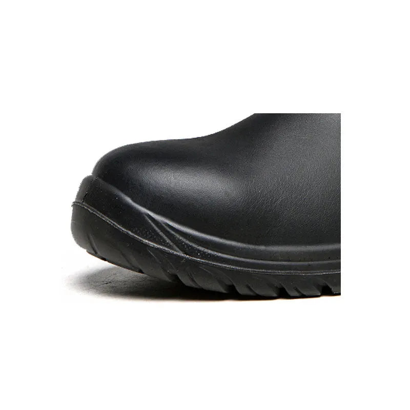 Black high-top leather safety work boots with anti-piercing sole on a work floor.