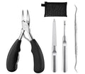 Stainless steel professional nail clipper and manicure tool set with olecranon scissors on a table