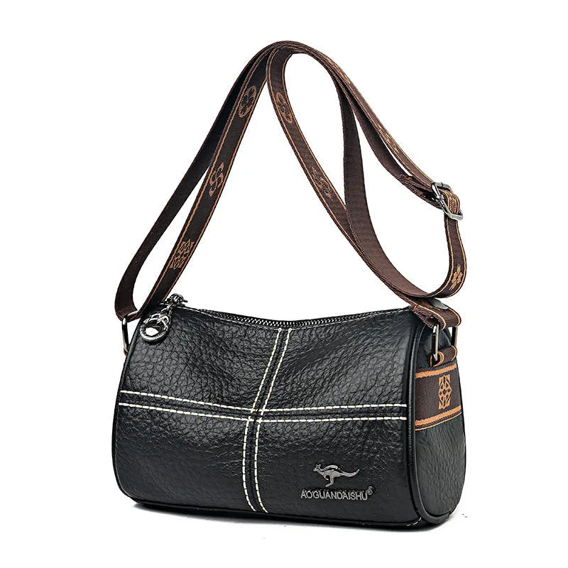 Casual genuine leather cylindrical shoulder bag for women in black, top grain, patchwork, soft texture.