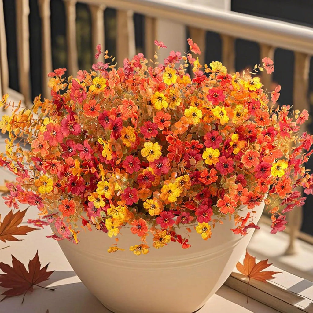 Artificial silk flower bouquet in autumn colours of red, yellow, and orange for wedding and home decoration