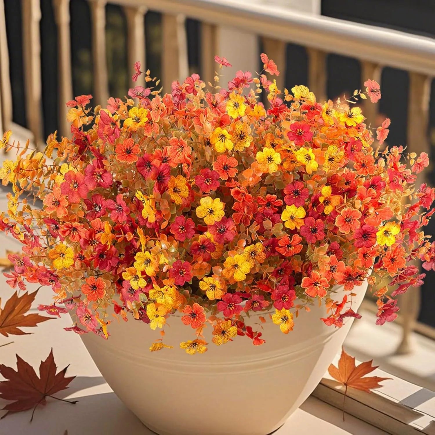 Artificial silk flower bouquet in autumn colours of red, yellow, and orange for wedding and home decoration