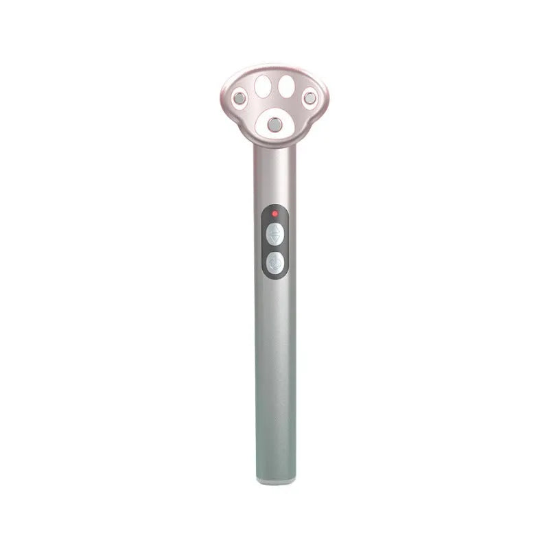 Gradient pink Cat's Paw micro-current eye massager with charging cable.