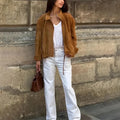 Retro-style loose-fit solid colour jacket with long sleeves on a hanger.