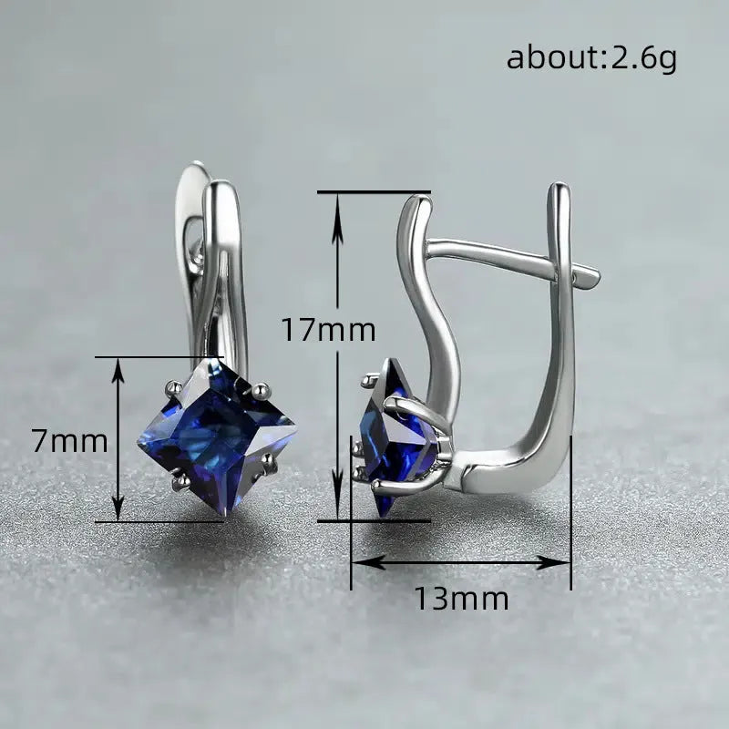 A pair of women's diamond-shaped copper earrings with inlaid zircon stones, shown in a blue colour variant.