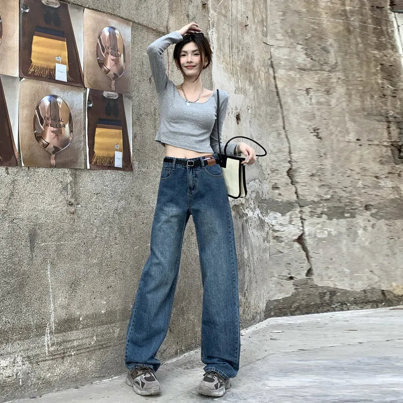 Women's high-waist retro blue straight-leg jeans on a model, showing the classic fit.