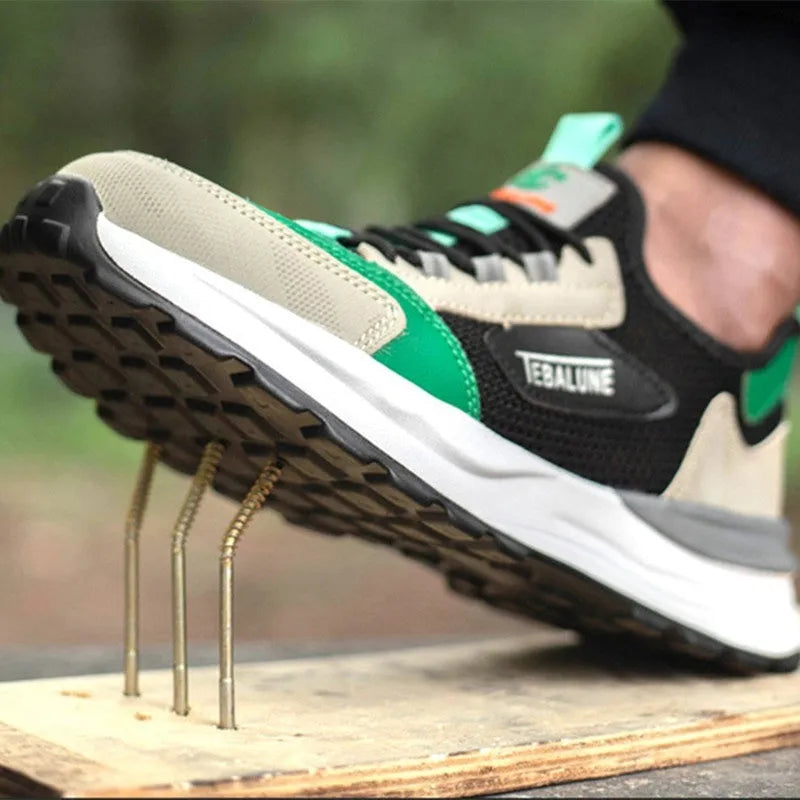 Black and green men's safety shoes with a mesh upper and plastic steel toe cap on a white background.