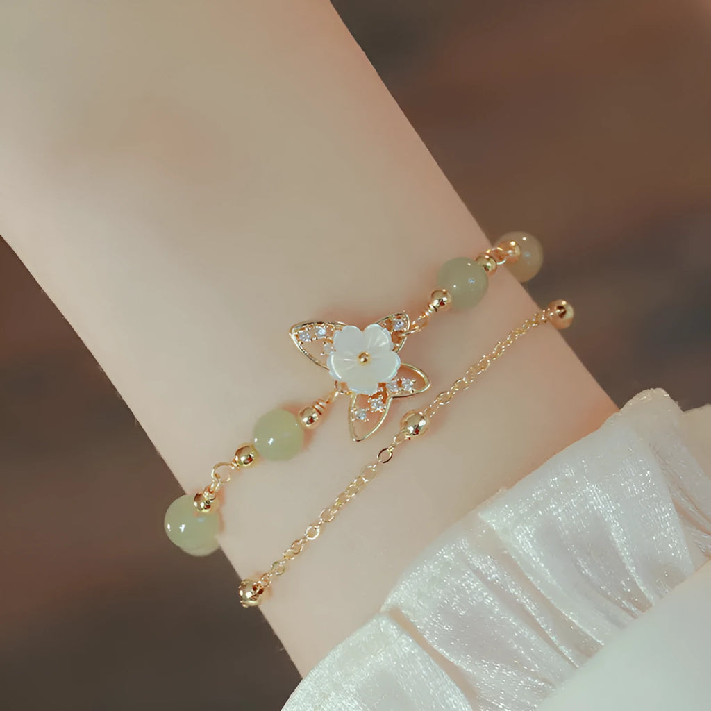 Yellow gold electroplated copper butterfly bracelet with geometric shape and bells of Ireland Hetian jade charm