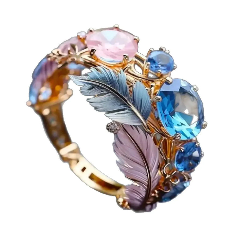 Gold-colour geometric brass ring with an embossed colourful feather design and zircon inlay.