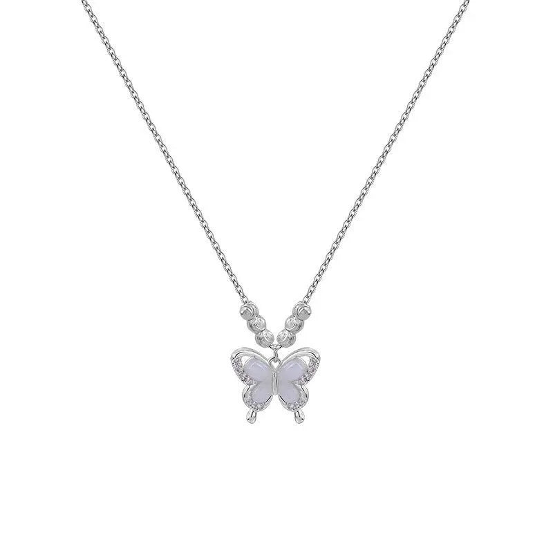 Silver butterfly pendant necklace with opal detail on cross chain