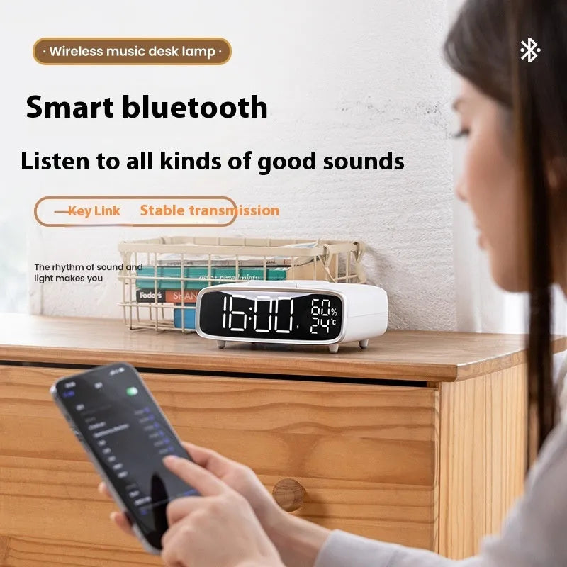 White Bluetooth speaker wireless charger with night light functionality on bedside table