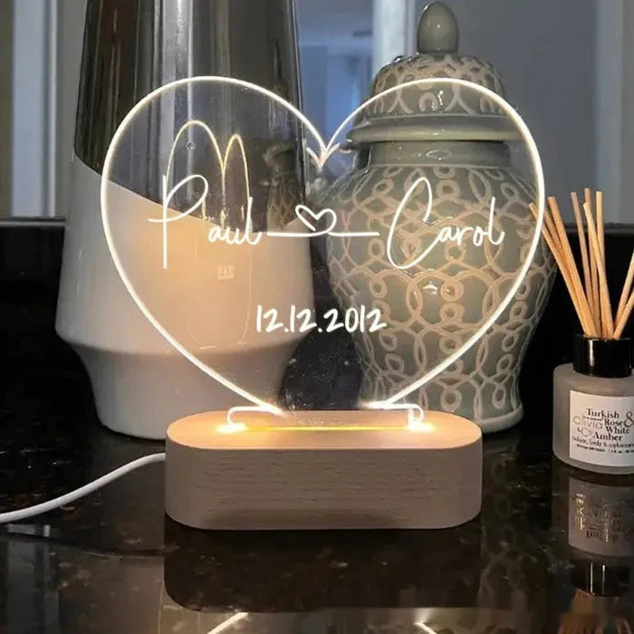 Custom acrylic night light with illuminated personalised names and dates for bedroom