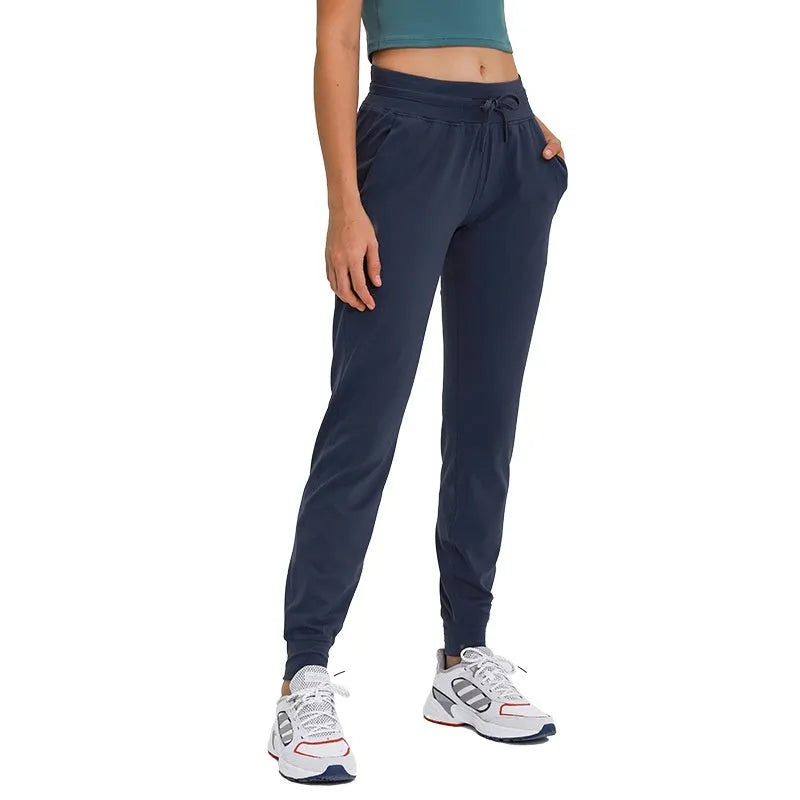 Women's high waist yoga pants with drawstring waistband in blue, shown for fitness use.