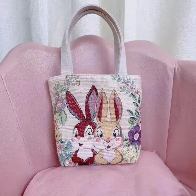 Canvas embroidery handbag with gold wire detail shown in an artistic colour design.
