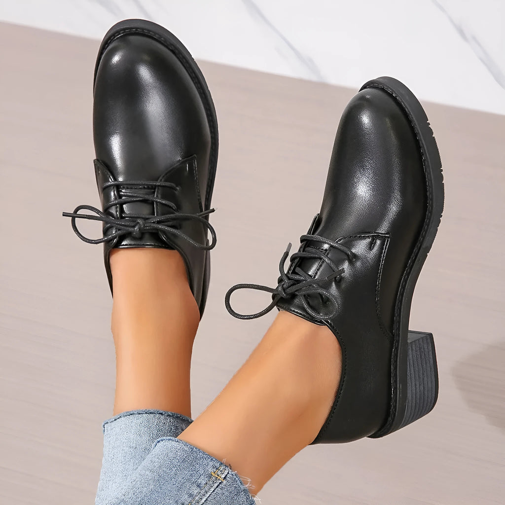 Black women's low-top PU leather shoes with a chunky mid-heel and pointed toe.