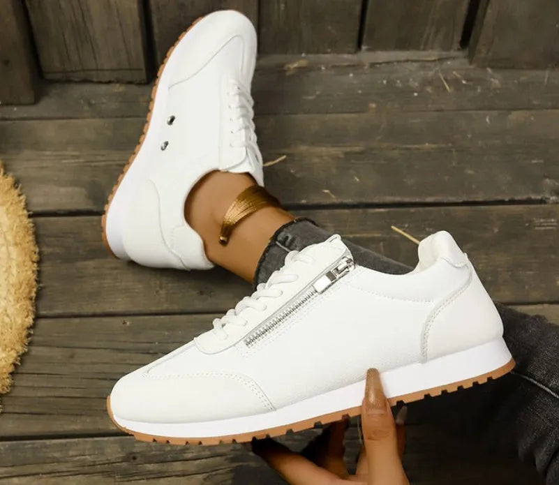 Women's flat shoe in artificial PU, rubber sole, shown in grey, white, or Champagne colour.