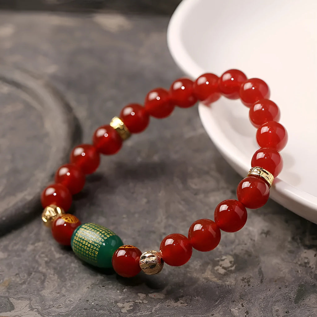 New Chinese style red agate Guanyin bracelet with auspicious patterns on a wrist.