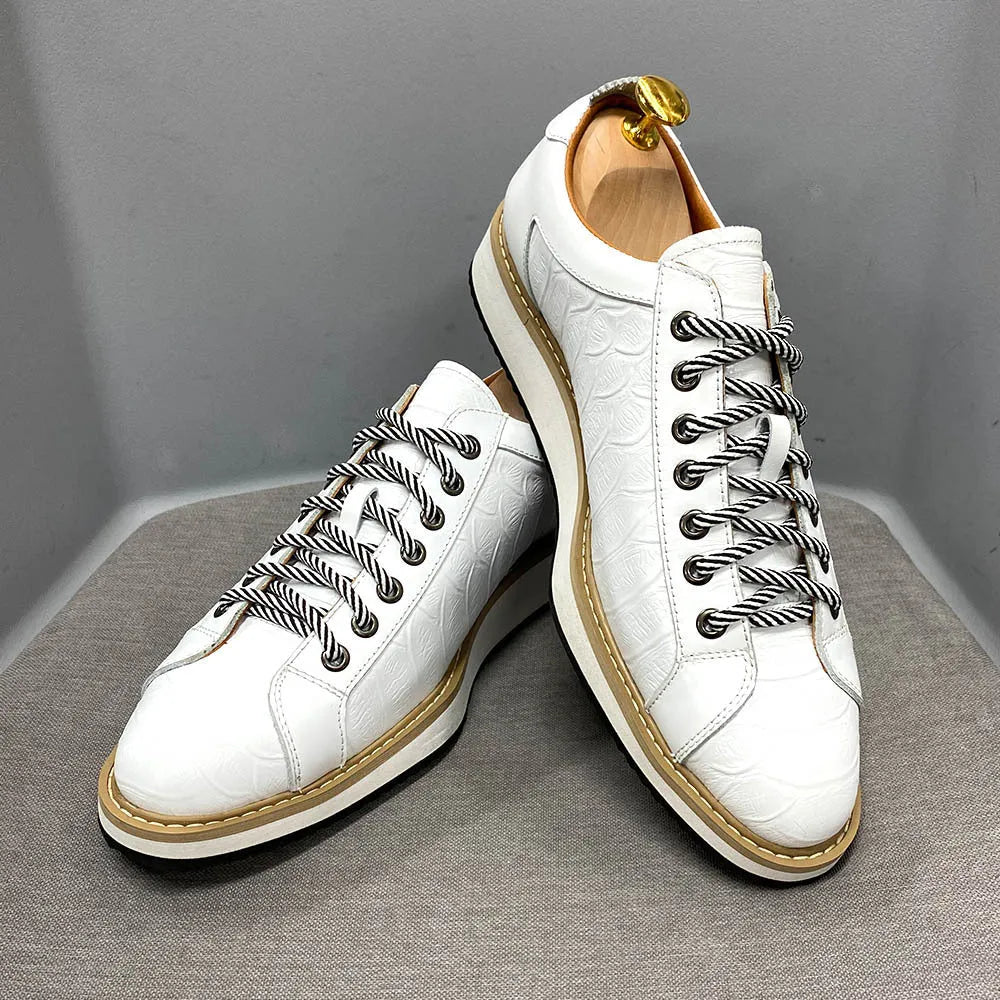 Men's low-top handmade shoes with embossed pattern and front-tie laces.