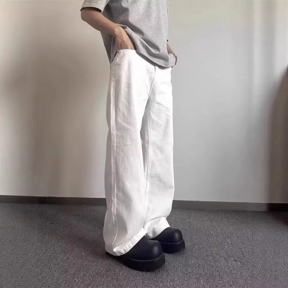 Men's white denim jeans with loose straight wide leg cut and mid waist