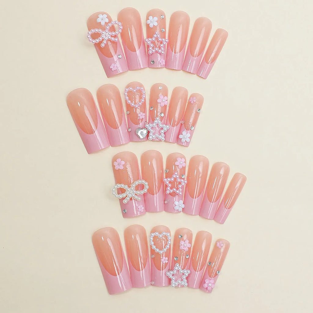 French style stick-on false nails with a love pattern and bow detail in colour XB-70-48 on a plastic armour suit.