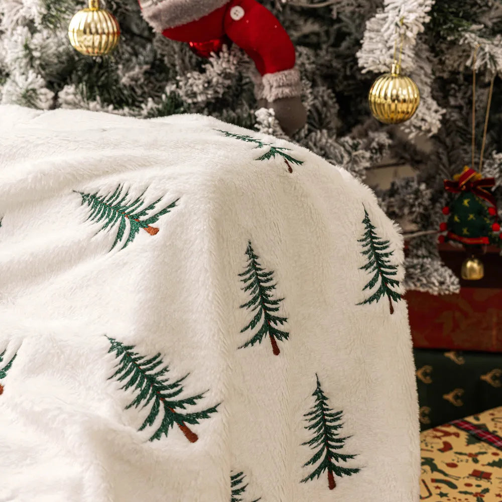 White polyester Christmas plush sofa blanket with embroidered Christmas tree on a sofa