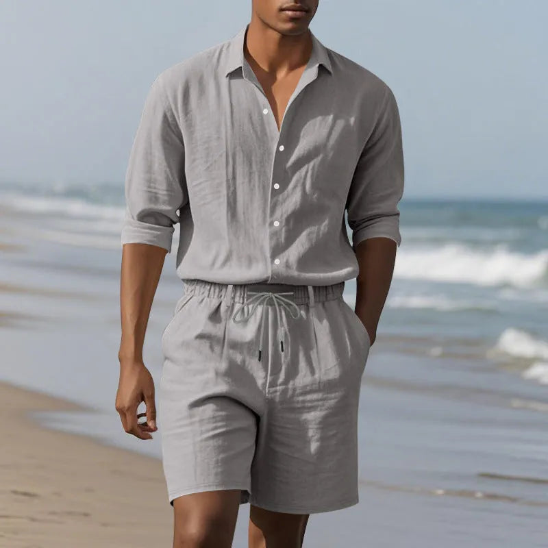 Men's linen long sleeve shirt and shorts beach suit set on a hanger, shown in a light blue colour.