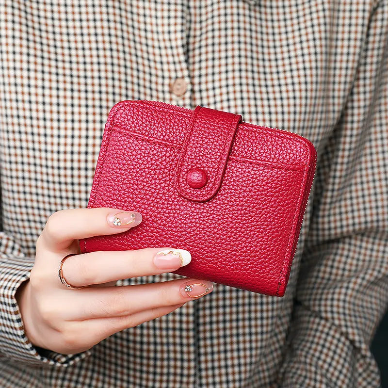 Women's beige lychee pattern short wallet made of PU, showing sewing thread detail and open organiser compartments.
