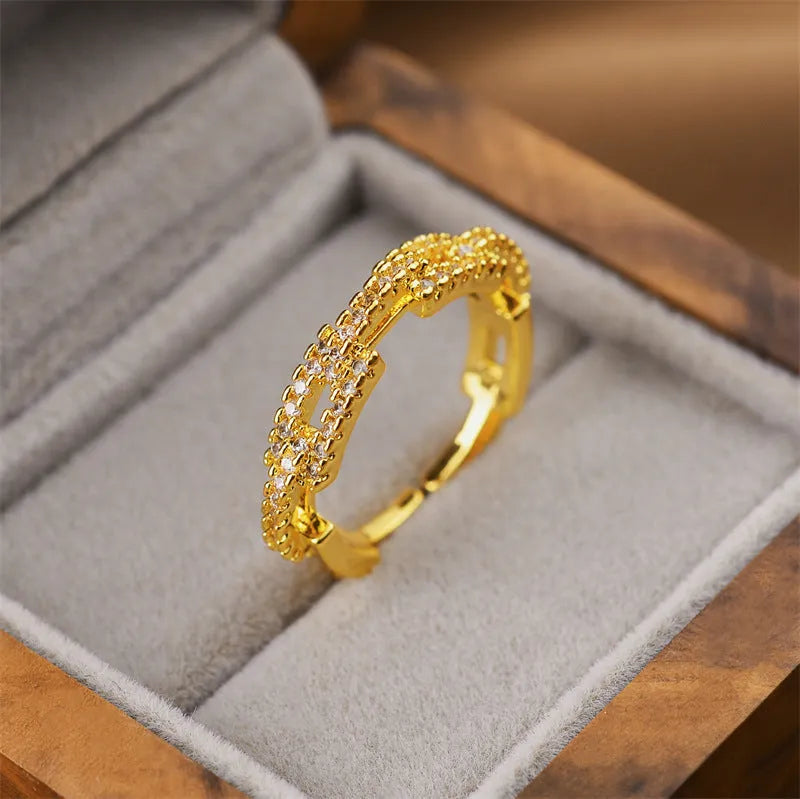 Gold electroplated geometric open ring on a finger, showing adjustable design and Korean fashion style