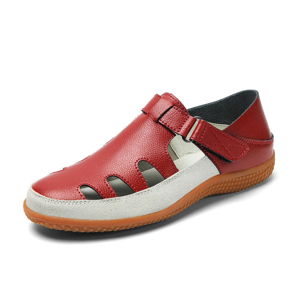 Women's flat sandals with hollow-out toe cap design in blue colour showing thick rubber sole