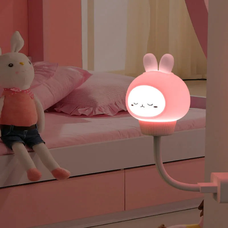 USB portable LED night light in cartoon bear shape with remote control on wooden table.