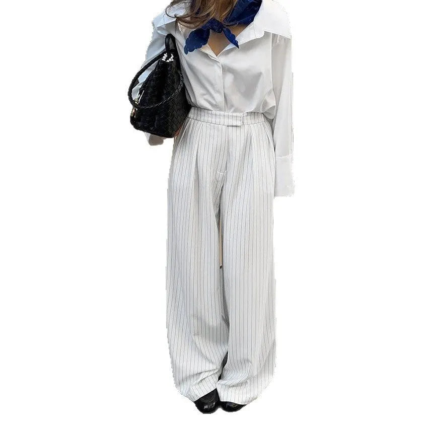White women's wide-leg trousers with a stripe detail and zip fastening, laid flat.