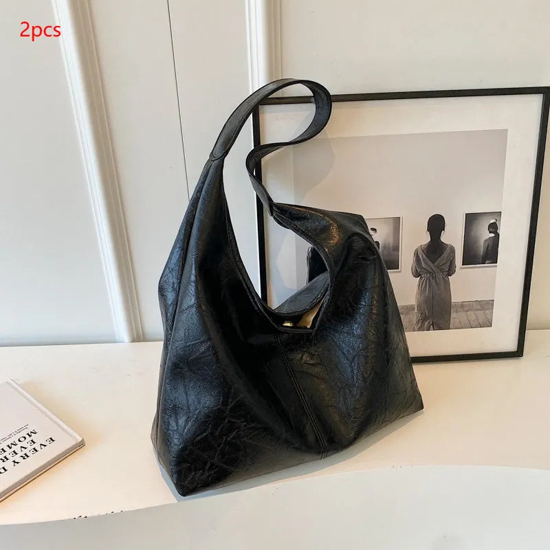 Casual soft PU leather shoulder bag in street trend style with large capacity and sandwich pocket.