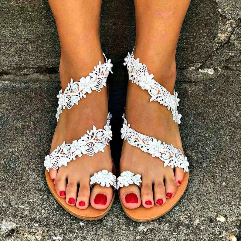 White women's flat shoes with rhinestone flower decoration on patent leather upper